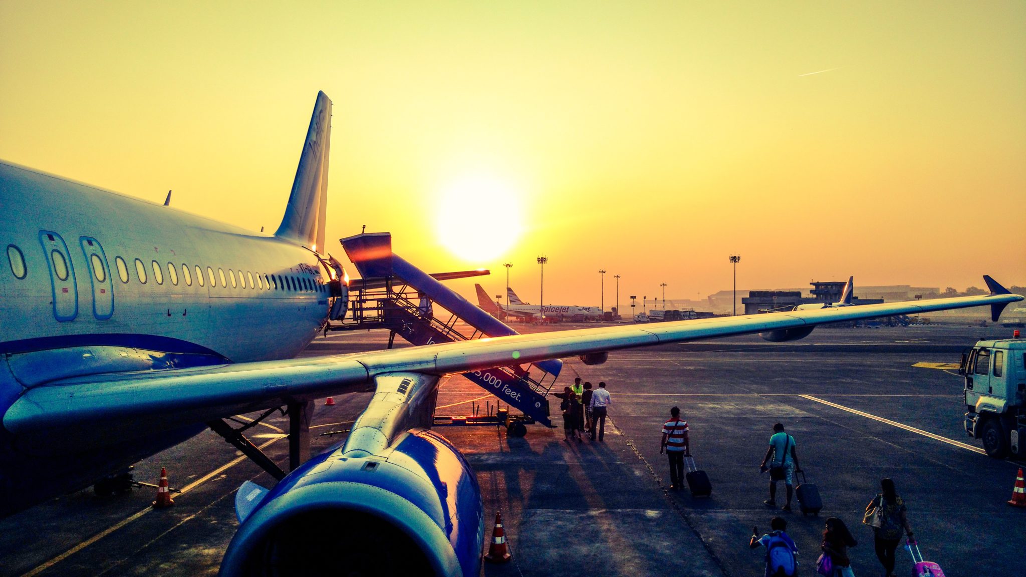 A plane before take-off, passengers are getting on board